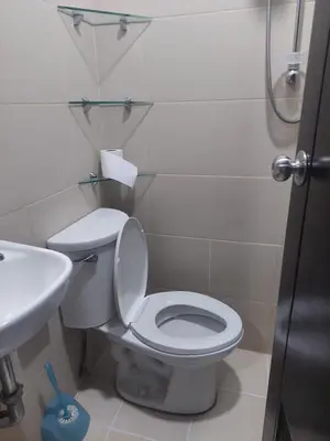 a bathroom with a toilet and a sink at Your HOME away from home in Manila