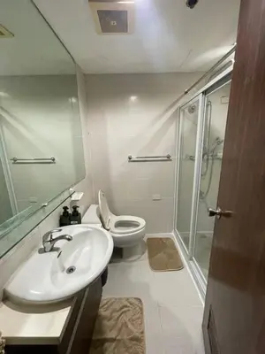 a bathroom with a sink and a toilet and a shower at A Venue Residences Tower 12L in Manila
