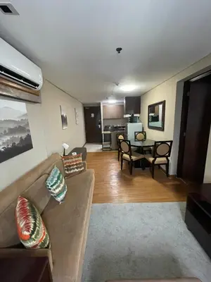 a living room with a couch and a table at A Venue Residences Tower 12L in Manila