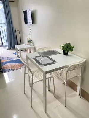 a white table and chairs in a living room at Shore 3 - Unit Chloe - Brand New and Relaxing 1BR in Manila