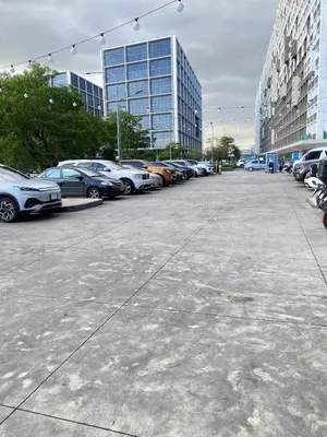 a parking lot with cars parked in front of a building at Shore 3 - Unit Chloe - Brand New and Relaxing 1BR in Manila