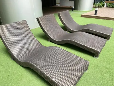 two empty chairs sitting on a green floor at Shore 3 - Unit Chloe - Brand New and Relaxing 1BR in Manila