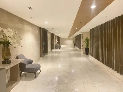 a hallway in a building with chairs and flowers at Shore 3 - Unit Chloe - Brand New and Relaxing 1BR in Manila