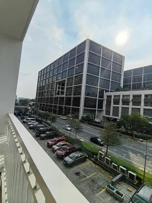 a large building with cars parked in a parking lot at Mk Luxury Vacation in Manila