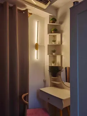 a bathroom with a toilet and a sink and shelves at Mk Luxury Vacation in Manila