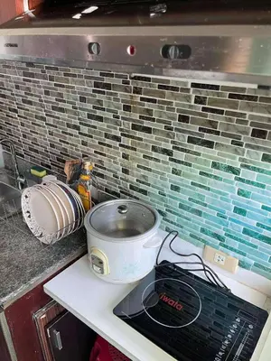 a kitchen counter with a stove and a pot on it at Anuva Staycation by Gina in Manila