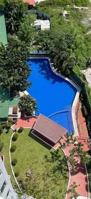 an overhead view of a large blue swimming pool at Anuva Staycation by Gina in Manila