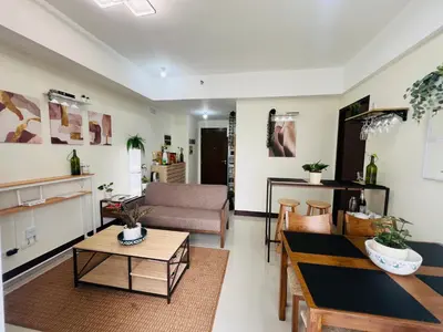 a living room with a couch and a table at Casa Tagpuan at Manhattan Heights in Manila