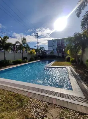 a large swimming pool in a yard next to a building at H&D Suites-Memories are personal in Anabu Primero