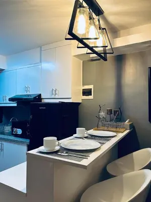 a kitchen with a table with plates on it at H&D Suites-Memories are personal in Anabu Primero