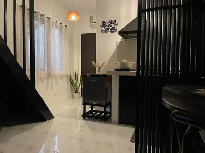 a kitchen with a table and a chair in a room at Binangonan Jarmelas Tiny Home with Free Breakfast in Binangonan