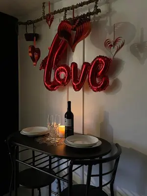 a table with a bottle of wine and a love sign at Binangonan Jarmelas Tiny Home with Free Breakfast in Binangonan