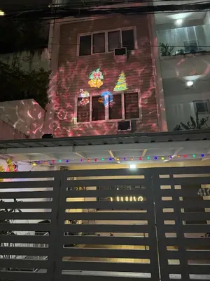 a house with a christmas tree on the side of it at Julie Annes Guesthouse in the Heart of the City in Manila