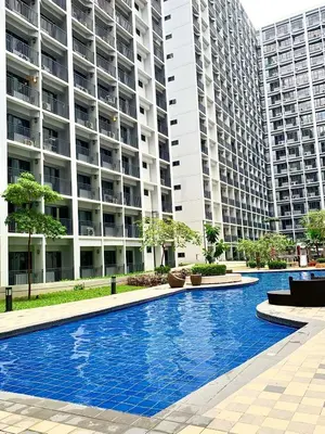 a swimming pool in front of a large apartment building at shore 2 residences tower 2 16fl in Manila