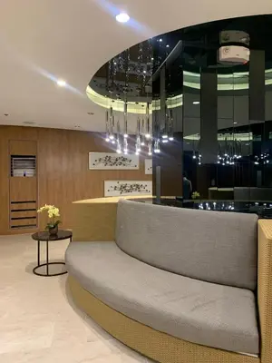 a lobby with a couch in front of a bar at shore 2 residences tower 2 16fl in Manila