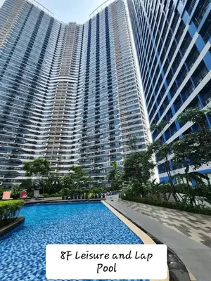 a large building with a swimming pool in front of it at Air Residence Makati in Manila