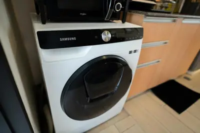 a washing machine with a microwave on top of it at Elegant unit, fast wifi, near Makati Medical Centr in Manila