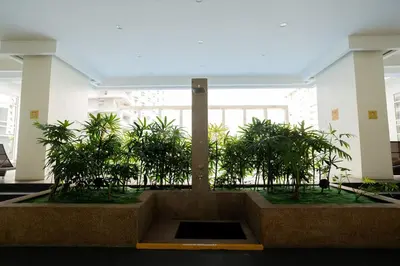 a planter with plants in the middle of a building at Elegant unit, fast wifi, near Makati Medical Centr in Manila