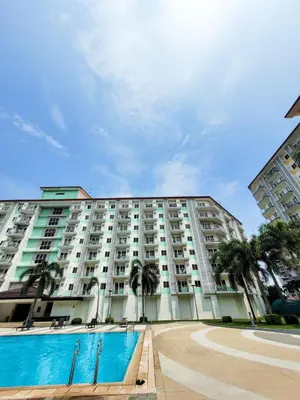 a large apartment building with a pool in front of it at An-Dy's Point, Field Residences in Manila