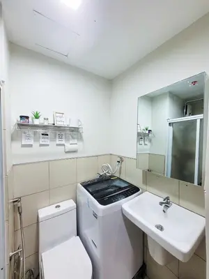 a small bathroom with a toilet and a sink at An-Dy's Point, Field Residences in Manila