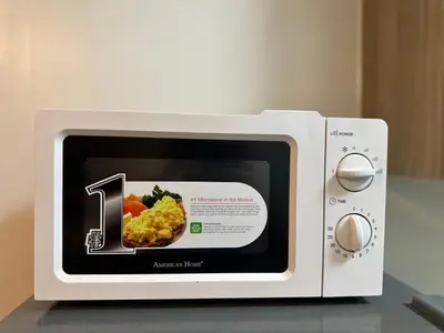 a microwave with a picture of food in it at Mall of Asia Vermilion Grand Suite in Manila