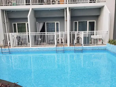 a large blue swimming pool in front of a building at La Luz 0835 Smdc Breeze in Manila