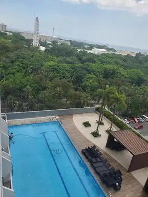 a view of the pool from the balcony of a hotel at La Luz 0835 Smdc Breeze in Manila