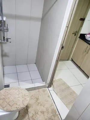 a small bathroom with a shower and a toilet at La Luz 0835 Smdc Breeze in Manila