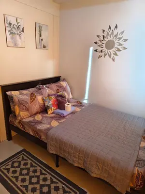 a bed in a room with a bed sidx sidx sidx at Sea Residence MOA - JULIZA STAYCATION in Manila