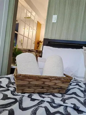 a basket with two pillows on a bed at Mk Luxury Staycation in Manila