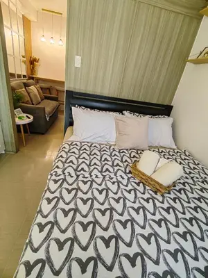 a bedroom with a bed with a black and white comforter at Mk Luxury Staycation in Manila