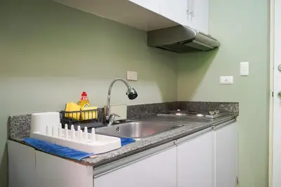 a kitchen with a sink and a counter top at Beautiful 1-Bedroom Condo in Makati - Pool, Gym & Near Airport in Manila