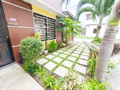 a walkway in front of a building with plants at Eco's Place GenTri - Family Bungalow in General Trias