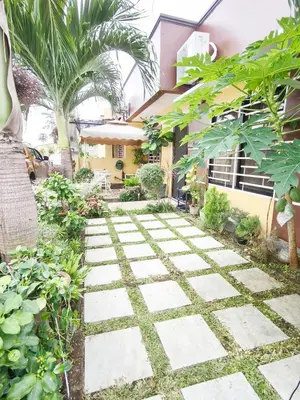 a garden with a walkway in front of a house at Eco's Place GenTri - Family Bungalow in General Trias