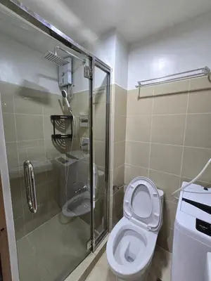 a bathroom with a toilet and a shower at Shore 3 Residences tower 3 in Manila