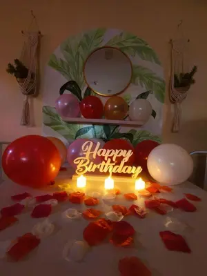a happy birthday cake with a candle and balloons at 2BR Pasig Condo for Family or Group with Parking in Manila