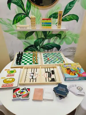 a table with a chess game and books on it at 2BR Pasig Condo for Family or Group with Parking in Manila