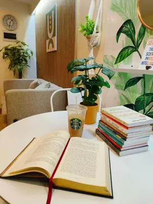 an open book on a table with a stack of books at 2BR Pasig Condo for Family or Group with Parking in Manila