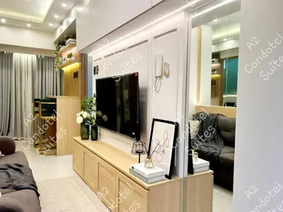 a living room with a tv and a couch at A2 Condotel Suites in Manila