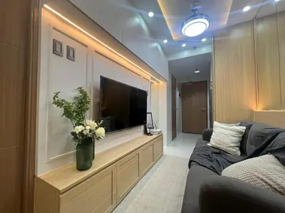 a living room with a large flat screen tv at A2 Condotel Suites in Manila