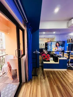 an office with a blue wall and a desk with a tv at Pinecrest Residential Condominium Newport Pasay City in Manila