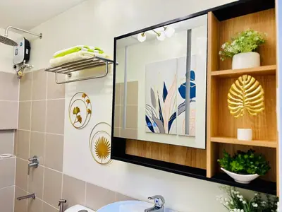 a bathroom with a mirror above a sink at Cozy Escape Satori Residences Santolan in Manila