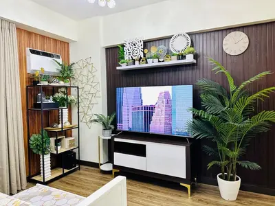 a living room with a flat screen tv at Cozy Escape Satori Residences Santolan in Manila