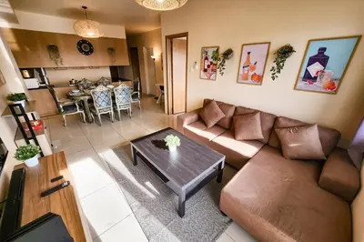 a living room with a couch and a table at Spacious 2br 110sqm, near MOA, PS4, Printer in Manila