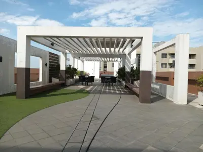 an outdoor patio with a white pergola at Radiance manila bay in Manila