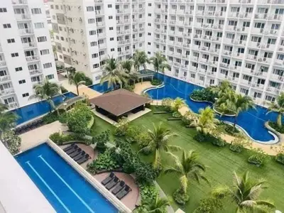 an aerial view of a large apartment building with a pool at EmFress Suites in Manila