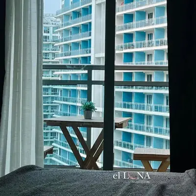 a picnic table in front of a large building at Rio West Tower - Azure Urban Resort Residences in Manila