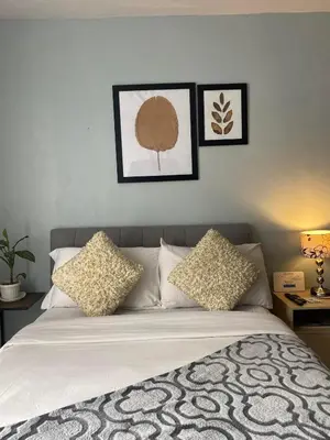 a bedroom with a bed with three pictures on the wall at Ohana buenbyahe affordable staycation at F RESIDENCEs near at mrt shaw megamall and starmall in Manila