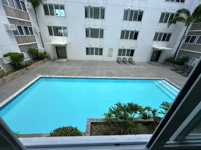 a large swimming pool in front of a building at Stanford Suites 1 in Silang