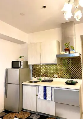 a kitchen with white cabinets and a refrigerator at Man-made beach waves 19 minutes from NAIA in Manila